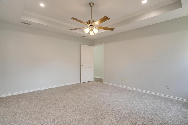 carpeted spare room featuring ceiling fan, recessed lighting, visible vents, baseboards, and a raised ceiling