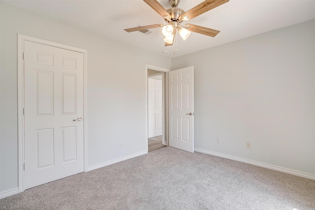 unfurnished bedroom with a ceiling fan, light colored carpet, and baseboards