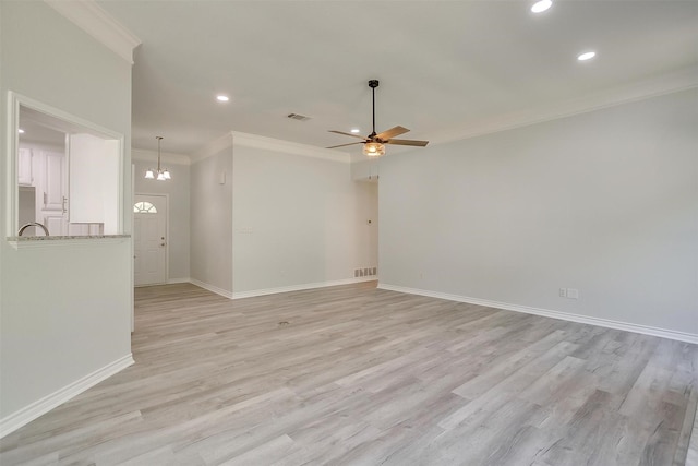 unfurnished room featuring light wood finished floors, baseboards, visible vents, ornamental molding, and ceiling fan with notable chandelier