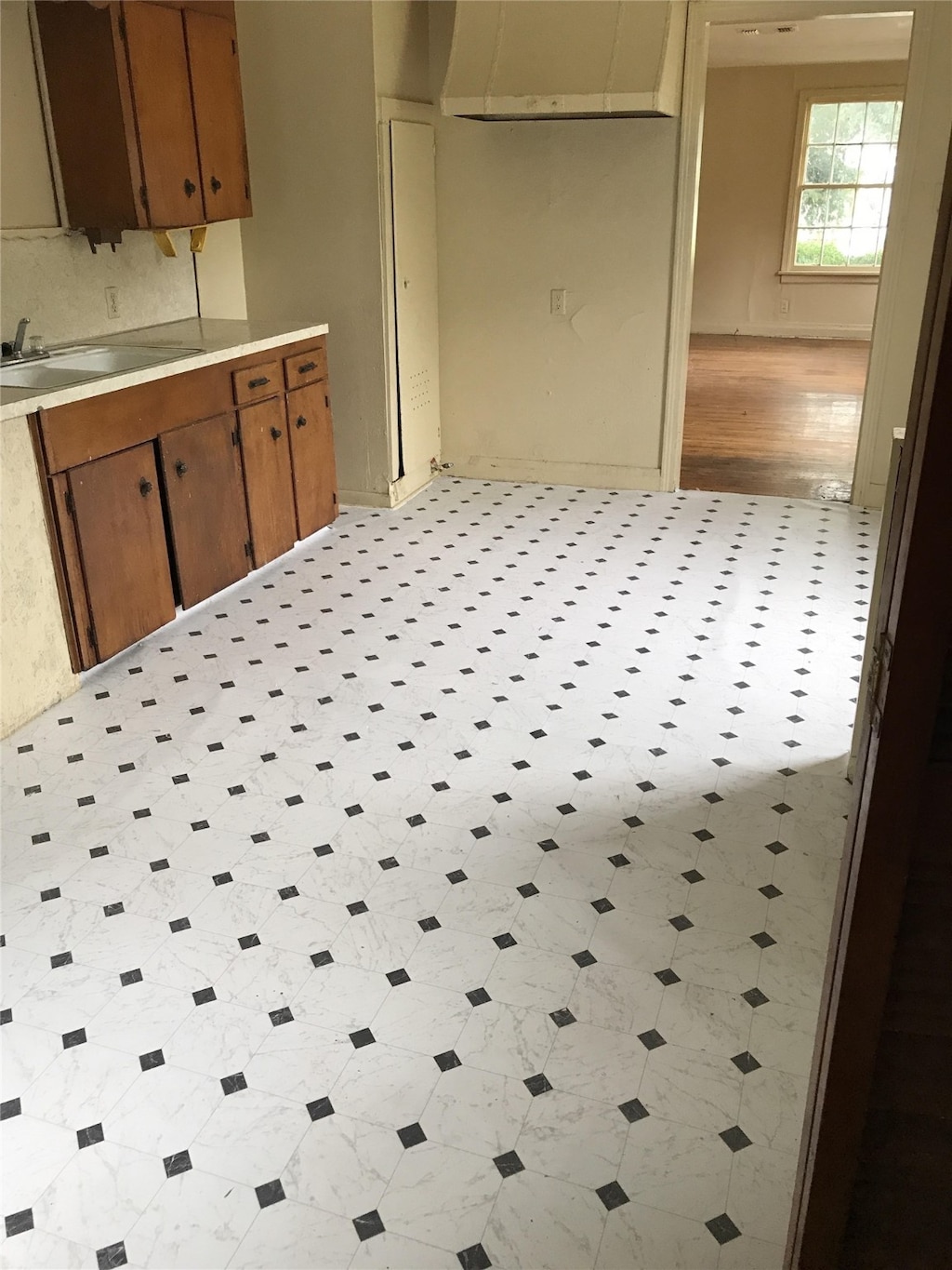 kitchen with light tile patterned floors, sink, and decorative backsplash