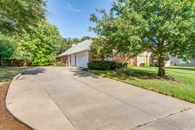 obstructed view of property featuring a front yard and a garage