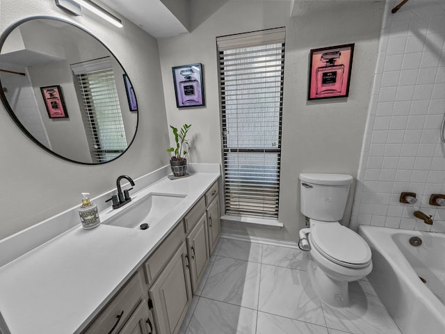 full bathroom featuring tiled shower / bath combo, vanity, and toilet