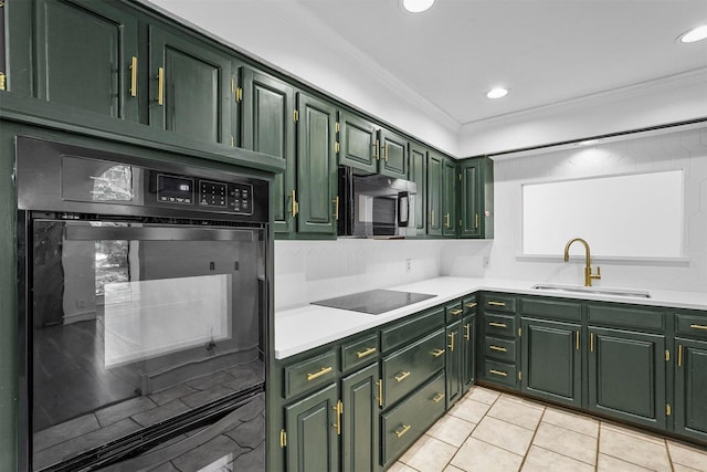 kitchen with green cabinets, light tile patterned floors, black appliances, ornamental molding, and sink