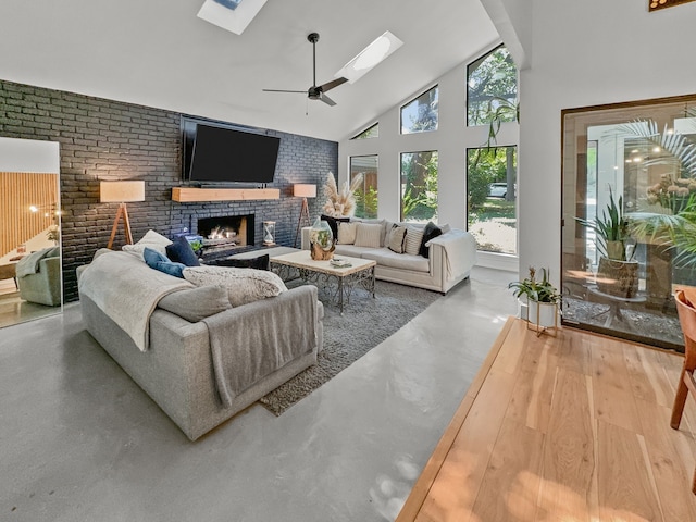 living room with a brick fireplace, high vaulted ceiling, ceiling fan, and a healthy amount of sunlight