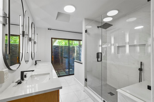 bathroom with tile patterned flooring, a shower with shower door, and vanity