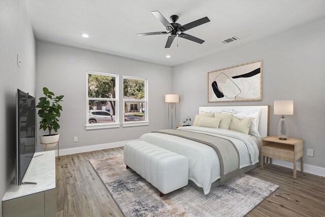 bedroom with ceiling fan and hardwood / wood-style flooring