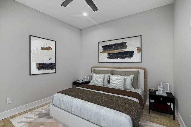 bedroom with ceiling fan and light hardwood / wood-style flooring