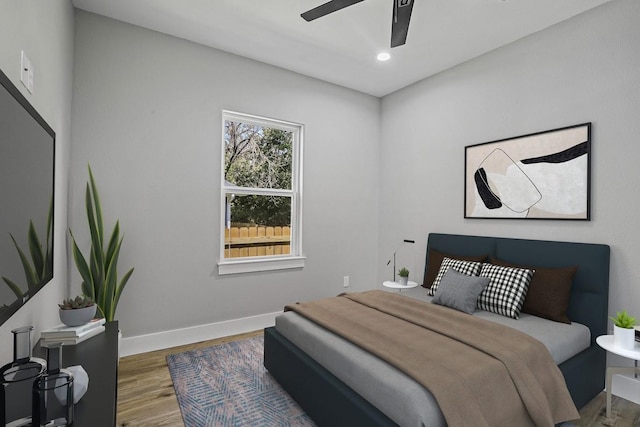 bedroom with a ceiling fan, recessed lighting, baseboards, and wood finished floors