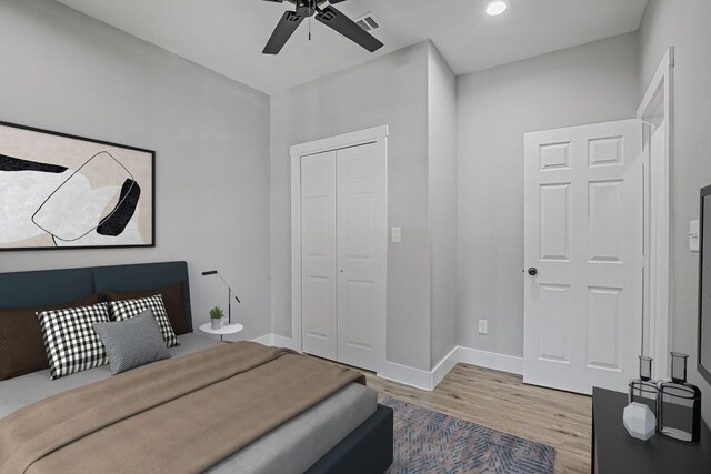 bedroom featuring ceiling fan, light wood-type flooring, and a closet