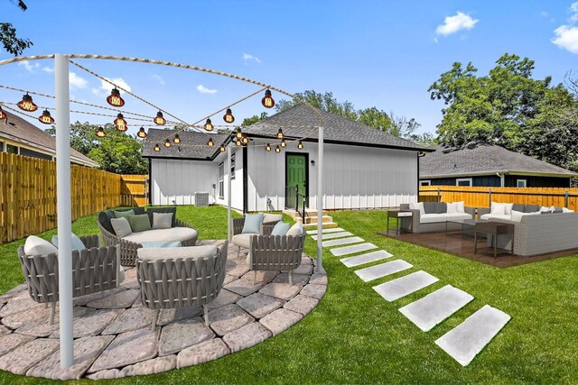 rear view of property featuring a lawn, outdoor lounge area, and a patio