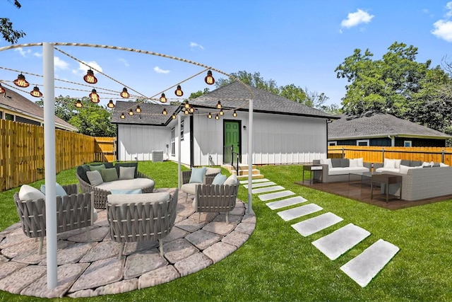 back of house with fence, an outdoor hangout area, a lawn, and a patio