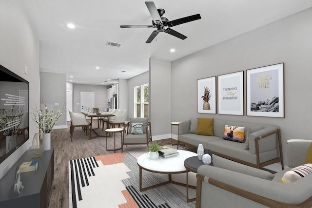 living room featuring recessed lighting, visible vents, ceiling fan, light wood-type flooring, and baseboards