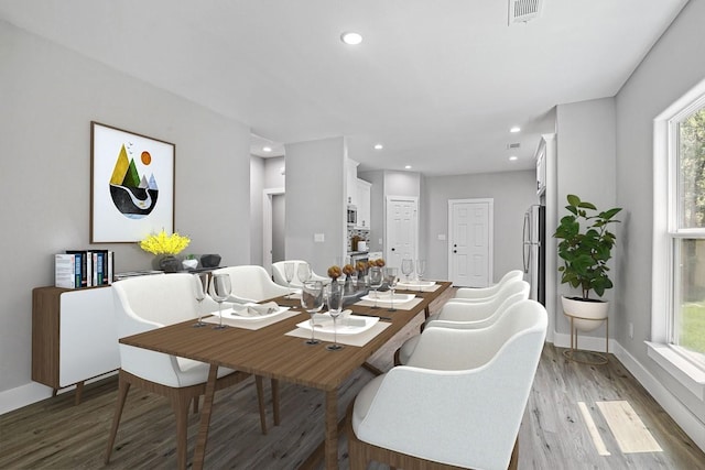 dining area with light wood-style flooring, visible vents, baseboards, and recessed lighting