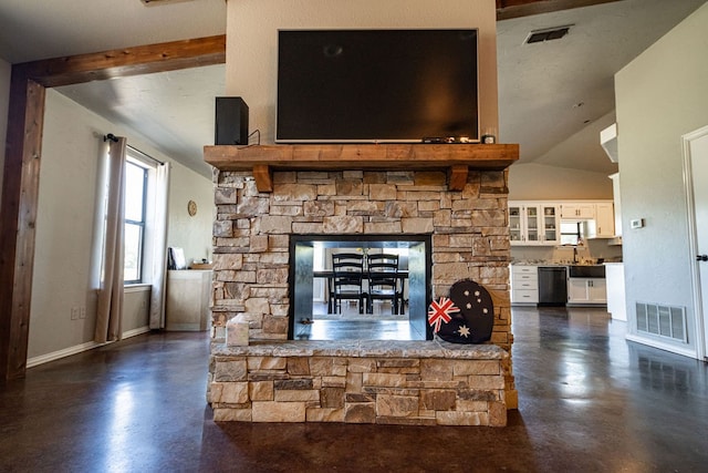 unfurnished living room featuring vaulted ceiling with beams and a stone fireplace