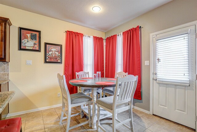 dining space with light tile patterned flooring