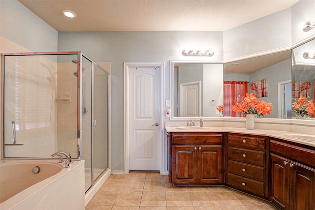 bathroom with tile patterned floors, shower with separate bathtub, and vanity