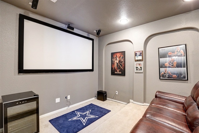 cinema featuring light colored carpet and a textured ceiling