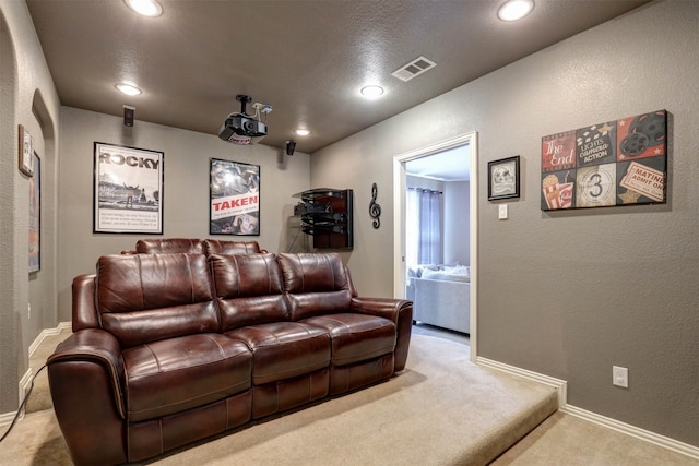 cinema room featuring light colored carpet