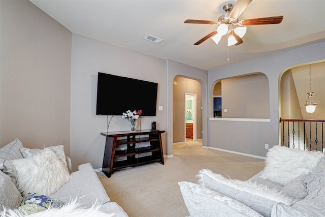 living room featuring ceiling fan and carpet