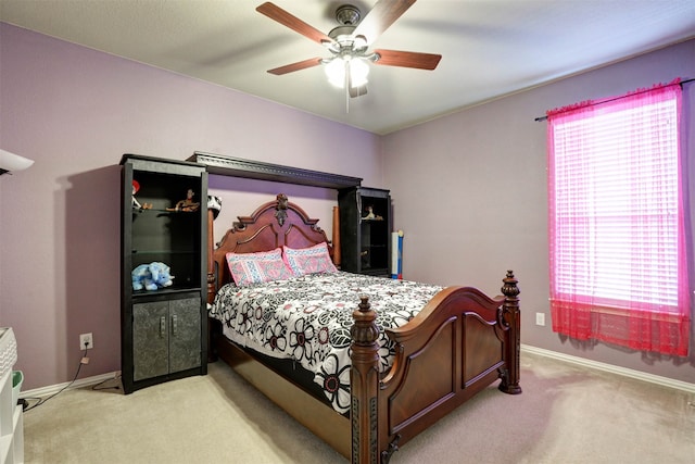 bedroom with ceiling fan, multiple windows, and carpet