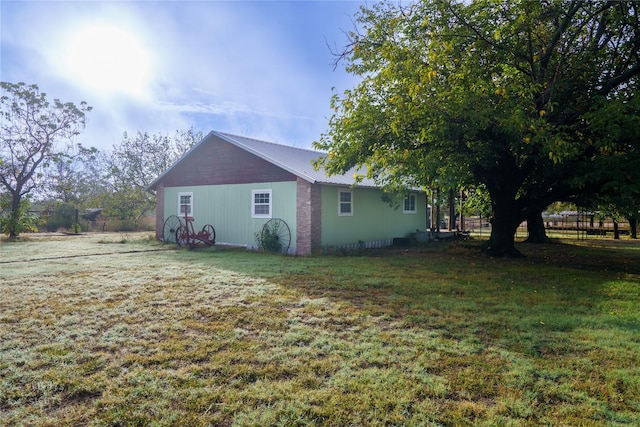 view of side of home featuring a lawn