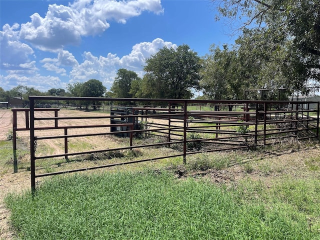 view of yard featuring a rural view and an outdoor structure