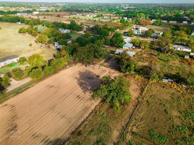 birds eye view of property with a rural view