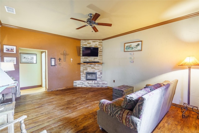 living room with a fireplace, wood-type flooring, ceiling fan, and crown molding