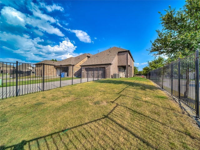 view of side of property with a shingled roof, fence, a lawn, and brick siding