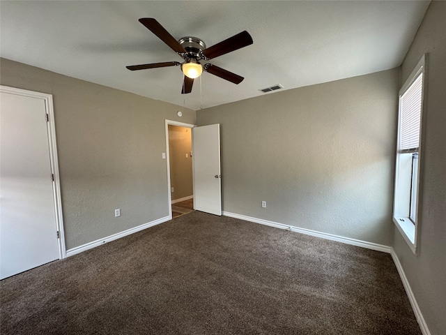 carpeted spare room with ceiling fan and a healthy amount of sunlight