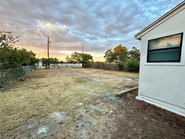 view of yard at dusk