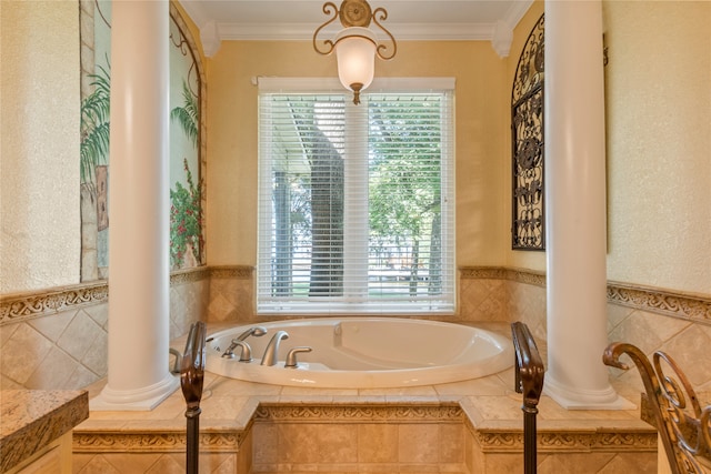 bathroom with ornate columns, tiled bath, and ornamental molding