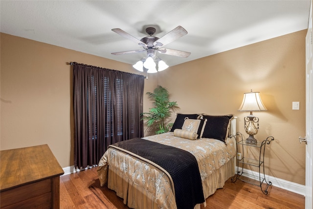 bedroom featuring ceiling fan and hardwood / wood-style floors