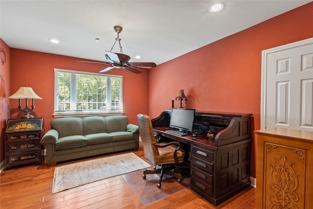 office space featuring ceiling fan and light hardwood / wood-style floors