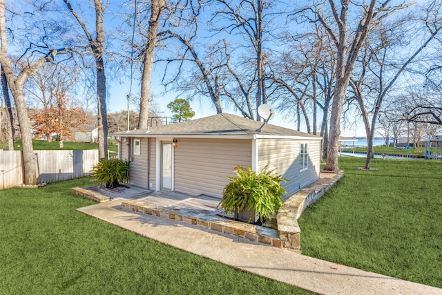 garage featuring a lawn and a water view