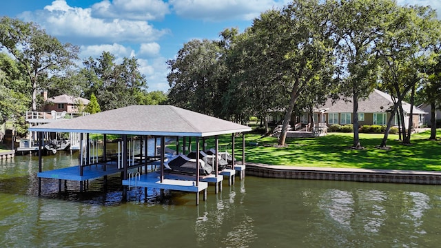 view of dock with a yard and a water view