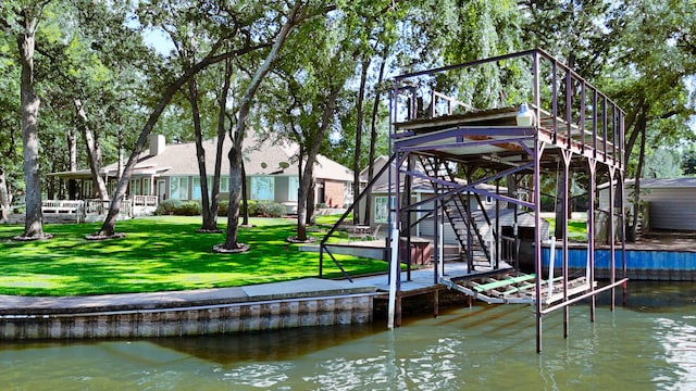 view of dock with a deck with water view and a yard