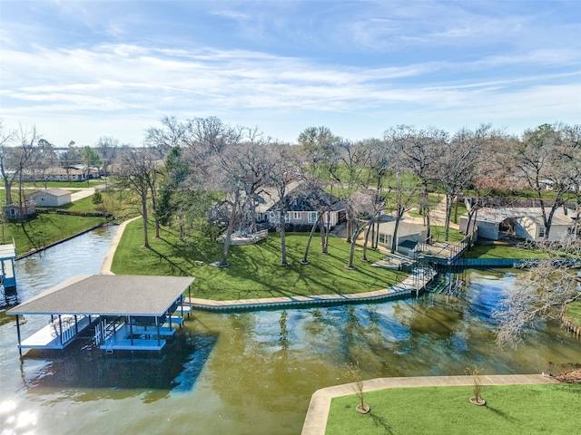 dock area with a water view and a yard