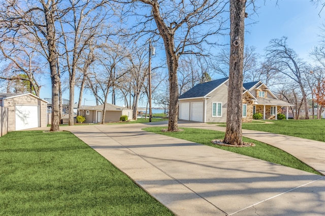 view of yard with a garage and an outbuilding