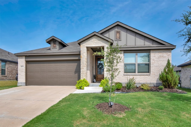 view of front of house featuring a garage and a front lawn