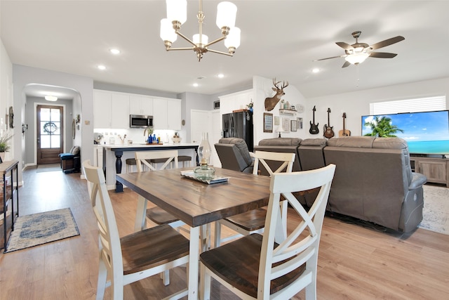 dining room featuring light wood-type flooring and ceiling fan with notable chandelier