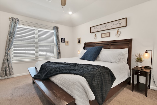 carpeted bedroom featuring ceiling fan and vaulted ceiling