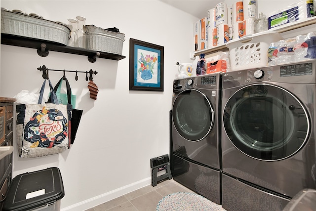 clothes washing area with light tile patterned floors and independent washer and dryer