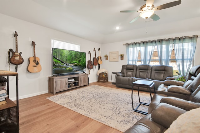 living room featuring ceiling fan and light hardwood / wood-style floors