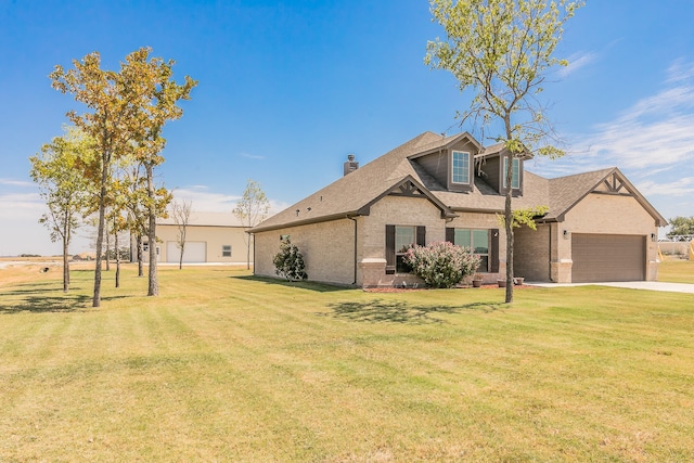 view of front of house featuring a garage and a front lawn