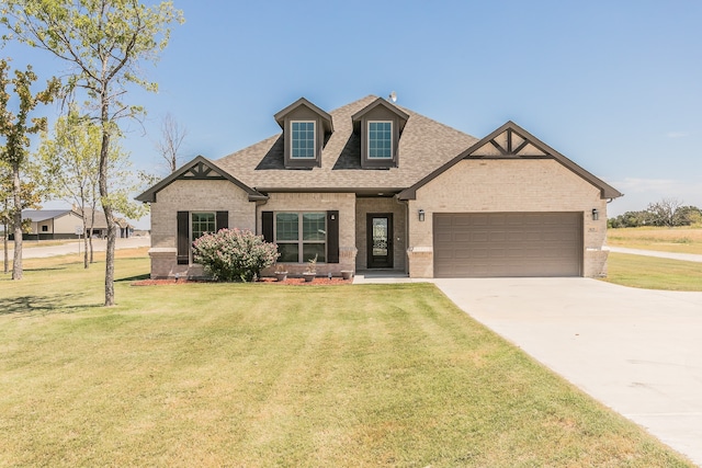 view of front of property featuring a garage and a front lawn