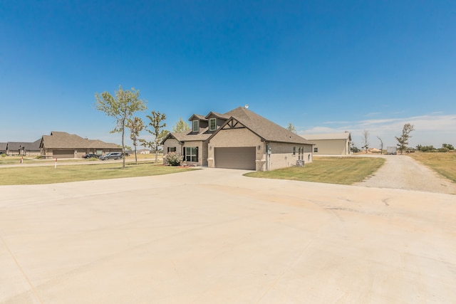 craftsman-style house featuring a garage and a front lawn