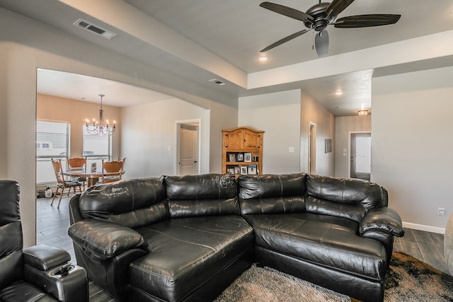 living room featuring hardwood / wood-style floors and ceiling fan with notable chandelier