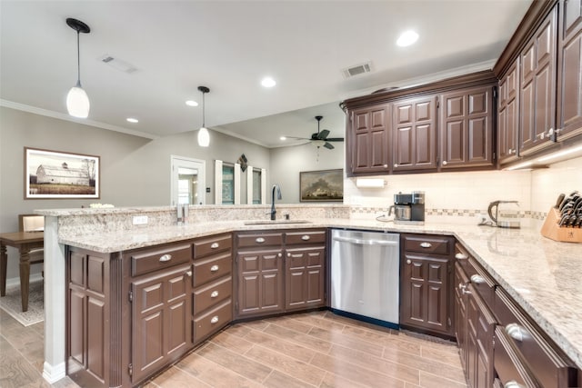 kitchen featuring dishwasher, ornamental molding, pendant lighting, kitchen peninsula, and ceiling fan