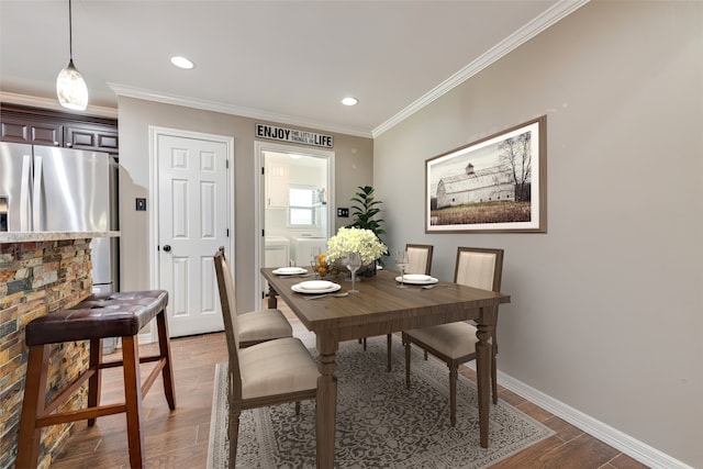 dining area featuring hardwood / wood-style flooring and ornamental molding